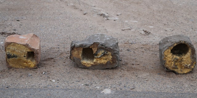 In this undated photograph provided by Conflict Armament Research, an independent London-based group that researches battlefield weaponry, three explosives disguised as rocks are on display in Yemen.
