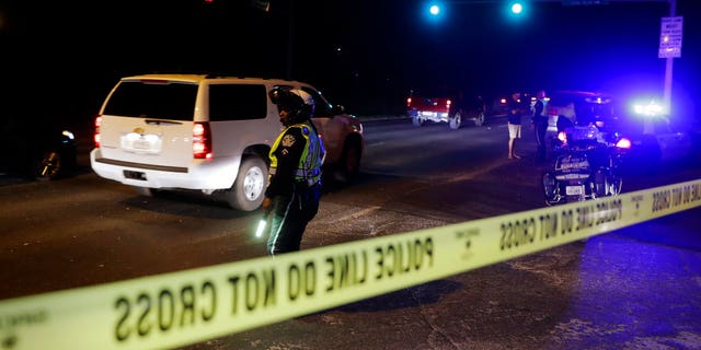 Police continue to restrict access to the neighborhood at the site of Sunday's explosion, early Monday, March 19, 2018, in Austin, Texas. Multiple people were injured in the explosion Sunday night, and police warned nearby residents to remain indoors overnight as investigators looked for possible links to other package bombings elsewhere in the city this month. (AP Photo/Eric Gay)