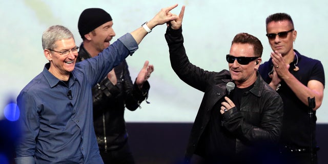 Sept. 9, 2014: Apple CEO Tim Cook, left, greets Bono from the band U2 after they preformed at the end of the Apple event in Cupertino, Calif.