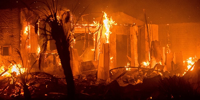 Dec. 8, 2017: Flames consume a structure as the Lilac fire burns in Bonsall, Calif.