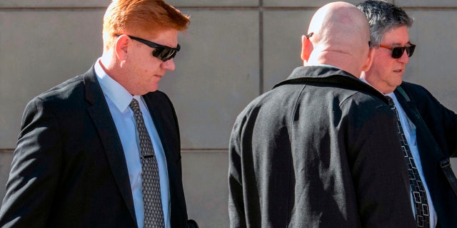 Border Patrol agent Lonnie Swartz, left, walks into federal court in Tucson, Ariz. in March 2018.