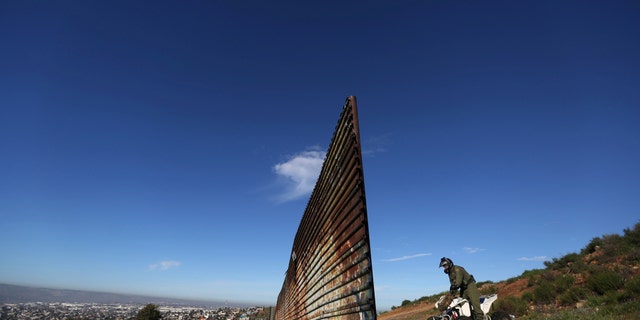 File photo: A member of the U.S. border patrol inspects the area where the border fence separating Mexico and the United States is interrupted, on the outskirts of Tijuana, Mexico, February 21, 2017. (REUTERS/Edgard Garrido)