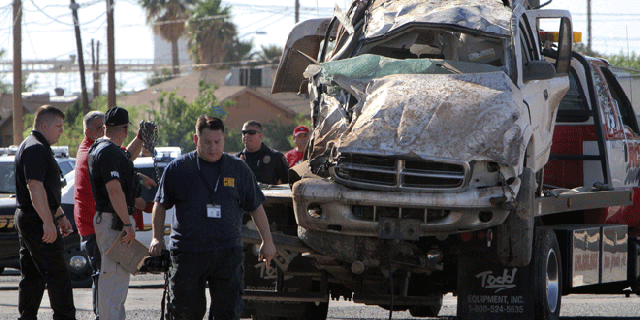 May 2, 2012: Investigators look over a vehicle that crashed and rolled following a pursuit by U.S. Border Patrol agents in Casa Grande, Ariz.