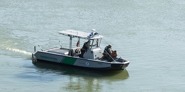 Border Patrol agents pull a man from the Rio Grande into their patrol boat near Roma, Texas Tuesday, April 18, 2017.