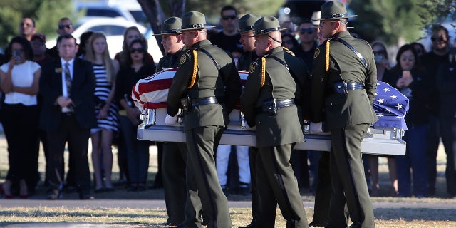 Border Patrol pallbearers carry Border Patrol agent Rogelio Martinez to a graveside service at Restlawn Cemetery, Saturday, Nov. 25, 2017 in El Paso, Texas. Martinez was on patrol in the Big Bend Sector when he died in the line of duty.