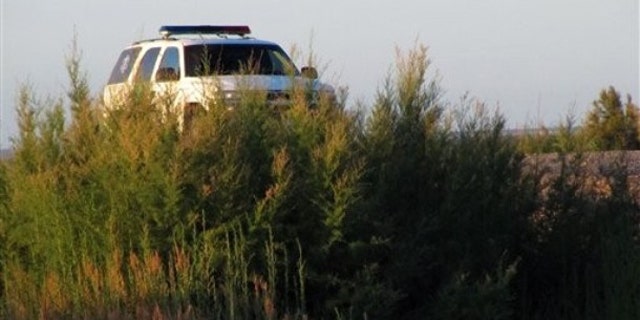 FILE: A U.S. Border Patrol truck is seen parked above a footbridge connecting Mexico with Texas. It would not be abandoned in the event of a government shutdown.