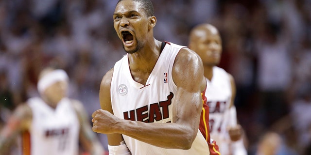 Miami Heat center Chris Bosh (1) reacts against the Indiana Pacers during the first half of Game 7 in their NBA basketball Eastern Conference finals playoff series, Monday, June 3, 2013 in Miami. (AP Photo/Lynne Sladky)