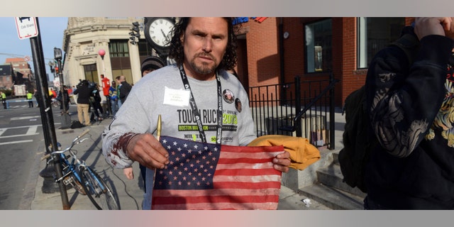 BOSTON, MA - APRIL 15: Carlos Arredondo, who was at the finish line of the 117th Boston Marathon when two explosives detonated, leaves the scene on April 15, 2013 in Boston, Massachusetts. Two people are confirmed dead and at least 28 injured after at least two explosions went off near the finish line to the marathon. (Photo by Darren McCollester/Getty Images)