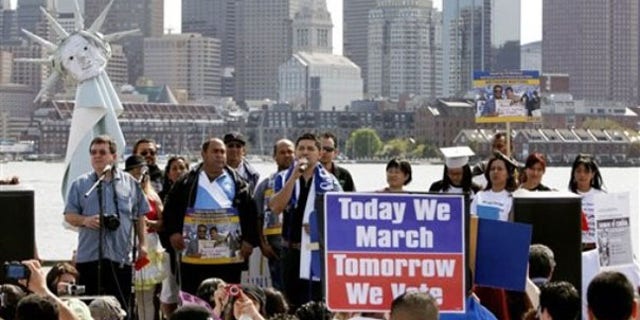 Protesters gather across the harbor from downtown Boston to demand immigration reform and denounce the controversial Arizona immigration law May 1. (AP Photo)