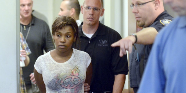 July 19, 2013: Audrea Gause, 26, of Troy, N.Y., is led into court in Troy, N.Y. to be arraigned on a Massachusetts fugitive warrant for defrauding the One Fund Boston of $480,000.