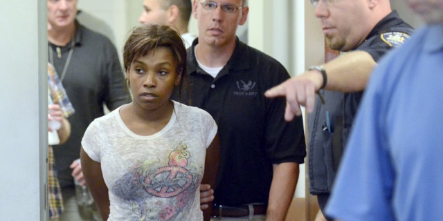 July 19, 2013: Audrea Gause, 26, of Troy, N.Y., is led into court in Troy, N.Y. to be arraigned on a Massachusetts fugitive warrant for defrauding the One Fund Boston of $480,000.