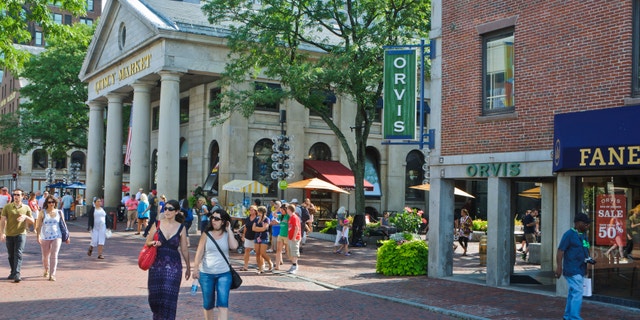 "Boston, Massachusetts, USA-August 7, 2012: Shoppers and tourists explore the outside and inside shops and restaurants of the historic Quincy Market complex on a beautiful August afternoon."