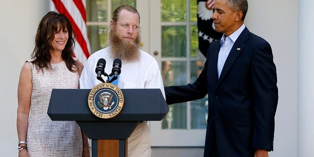 U.S. President Barack Obama (R) watches as Jami Bergdahl (L) and Bob Bergdahl talk about the release of their son, prisoner of war U.S. Army Sergeant Bowe Bergdahl, during a statement in the Rose Garden at the White House in Washington May 31, 2014. Obama, flanked by the parents of Army Sergeant Bowe Bergdahl, a U.S. soldier who is being released after being held for nearly five years by the Taliban, said in the White House Rose Garden on Saturday that the United States has an "ironclad commitment" to bring home its prisoners of war. REUTERS/Jonathan Ernst (UNITED STATES - Tags: POLITICS MILITARY) - GM1EA610J6201