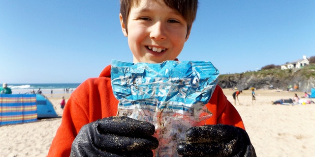 A 10-year-old boy who was cleaning up the beach was left shocked when he discovered a bag of chips from the 1980's.