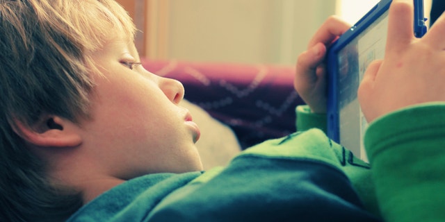 boy using laptop istock