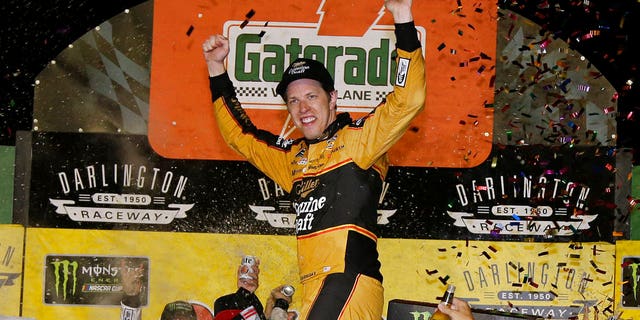 Brad Keselowski celebrates in Victory Lane after winning the NASCAR Cup Series auto race at Darlington Raceway, Sunday, Sept. 2, 2018, in Darlington, S.C. (AP Photo/Terry Renna)
