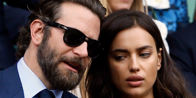 Actor Bradley Cooper, left, speaks with his then-girlfriend, supermodel Irina Shayk on the fourteenth day of the Wimbledon Tennis Championships in London, Sunday, July 10, 2016.