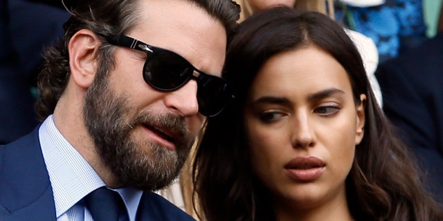 Actor Bradley Cooper, left, speaks with his then-girlfriend, supermodel Irina Shayk on the fourteenth day of the Wimbledon Tennis Championships in London, Sunday, July 10, 2016.