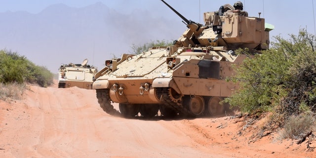 File photo - Soldiers assigned to Company B, 2nd Battalion, 198th Infantry Regiment, 155th Armored Brigade Combat Team, Mississippi Army National Guard, ride in a Bradley Fighting Vehicle after an exercise near the El Jarbah training village on Doña Ana Range, N.M., April 20, 2018. (Winifred Brown, Fort Bliss Public Affairs Office)