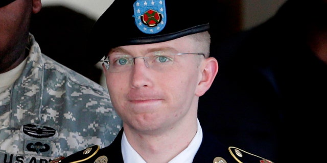 FILE: June 25, 2012: Army Pfc. Bradley Manning, right, is escorted out of a courthouse in Fort Meade, Md.