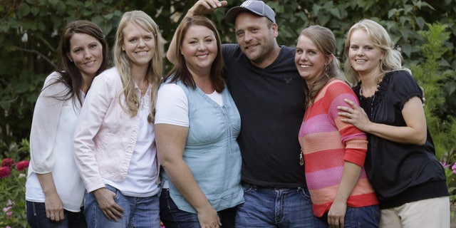 Sept. 11, 2013. Brady Williams poses with his wives, from left to right, Paulie, Robyn, Rosemary, Nonie, and Rhonda, outside of their home in a polygamous community outside Salt Lake City.