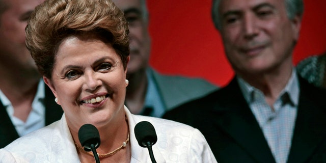 Oct. 26: Dilma Rousseff smiles during news conference after disclosure of the election results, in Brasilia.
