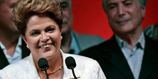 Oct. 26: Dilma Rousseff smiles during news conference after disclosure of the election results, in Brasilia.