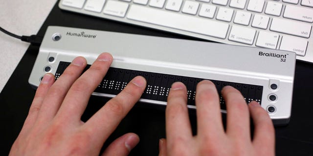 Victor Tsaran, co-director of Yahoo's "Accessibility Lab," uses a Braille keyboard at headquarters in Sunnyvale, Calif. The "Accessibility Lab lets programmers and developers try various assistive technology software and hardware such as screen readers, Braille keyboards and other tools employed by disabled users to navigate the Web.