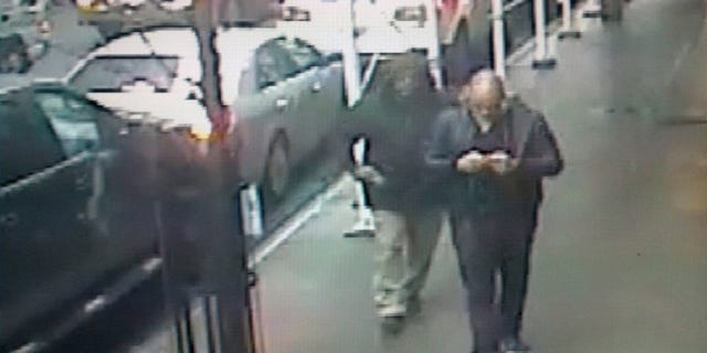 A gunman is seen pulling a weapon behind Brandon Lincoln Woodard (R) a moment before Woodward was shot in Manhattan, in this image taken from video and given to the media by the New York City Police Department, December 11, 2012.