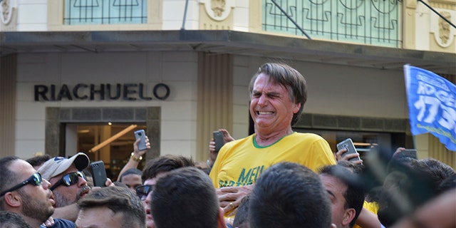 Brazilian presidential candidate Jair Bolsonaro grimaces after being stabbed in the stomach during a campaign rally in Juiz de Fora, Brazil on Thursday.