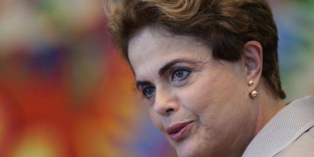 FILE - In this June 14, 2016 file photo, suspended Brazilian President Dilma Rousseff speaks during a press conference for foreign journalists at the Alvorada residential palace, in Brasilia, Brazil. Brazil's Senate voted Wednesday, Aug. 10, 2016, to put Rousseff on trial for allegedly breaking fiscal rules in her managing of the federal budget. (AP Photo/Eraldo Peres, File)
