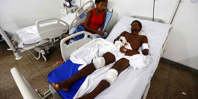 Jose Ribamar from Brazil's indigenous Gamela tribe is pictured next to his daughter at a hospital after he was injured in a dispute over land in northern Brazil, in Sao Luis, Maranhao state, Brazil, May 2, 2017.