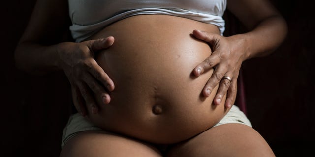 FILE - In this Feb. 5, 2016 file photo, Daniele da Silva, who is seven months pregnant, poses for a photo as she sits inside her home in a slum of Recife, Brazil. Da Silva said she had Chikungunya a couple of months ago and her ultrasound scan and other exams of her baby are normal. In Zika-struck Brazil, a debate over whether to loosen the countrys strict abortion laws has sparked a backlash from the mothers of children with birth defects. (AP Photo/Felipe Dana, File)