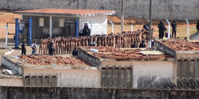 Jan. 15, 2017: Naked inmates stand in line while surrounded by police after a riot at the Alcacuz prison in Nisia Floresta, Rio Grande do Norte state, Brazi.