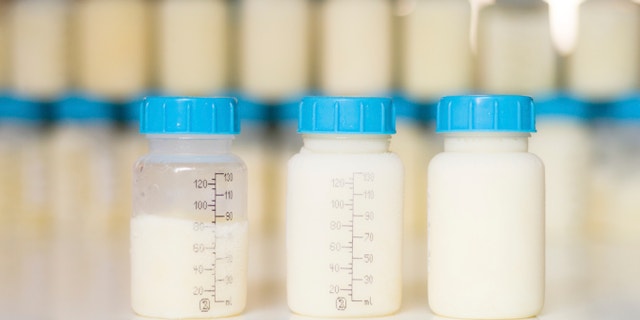 Breastfeeding and storage: Frozen mother milk with ice around the bottle freshly taken out of the freezer.