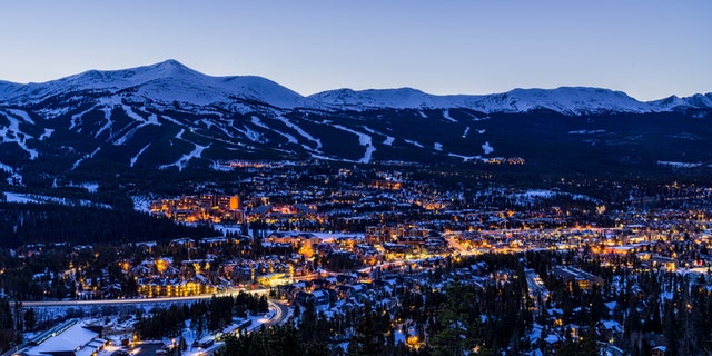 Breckenridge Colorado Winter Dusk Ski Runs - Landscape scenic at dusk during blur hour showing ski resort runs and town of Breckenridge lit up in winter. Breckenridge, Colorado USA.