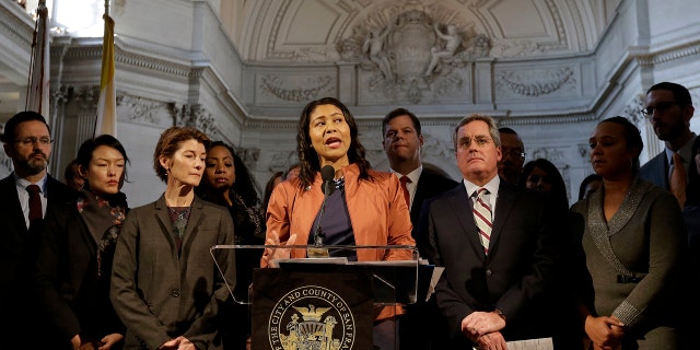 San Francisco Acting Mayor London Breed, center, speaks at a news conference at City Hall in San Francisco, Dec. 12, 2017.