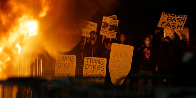 Protestors watch a bonefire on Sproul Plaza during a rally against the scheduled speaking appearance by Breitbart News editor Milo Yiannopoulos on the University of California at Berkeley campus on Wednesday, Feb. 1, 2017, in Berkeley, Calif. The event was canceled out of safety concerns after protesters hurled smoke bombs, broke windows and started a bonfire. (AP Photo/Ben Margot)