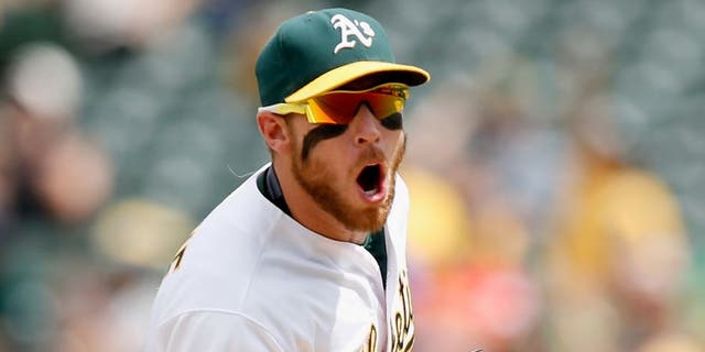 OAKLAND, CA - JULY 01: Brett Lawrie #15 of the Oakland Athletics reacts after he fielded the ball with his bare hand and threw out Ben Paulsen #10 of the Colorado Rockies in the sixth inning at O.co Coliseum on July 1, 2015 in Oakland, California. (Photo by Ezra Shaw/Getty Images)