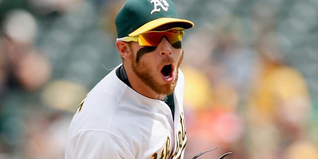 OAKLAND, CA - JULY 01: Brett Lawrie #15 of the Oakland Athletics reacts after he fielded the ball with his bare hand and threw out Ben Paulsen #10 of the Colorado Rockies in the sixth inning at O.co Coliseum on July 1, 2015 in Oakland, California. (Photo by Ezra Shaw/Getty Images)