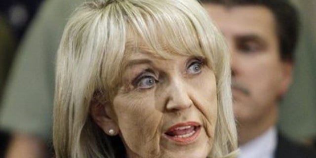 Arizona Gov. Jan Brewer speaks during a news conference after signing her state's immigration bill April 23 in Phoenix. (AP Photo)