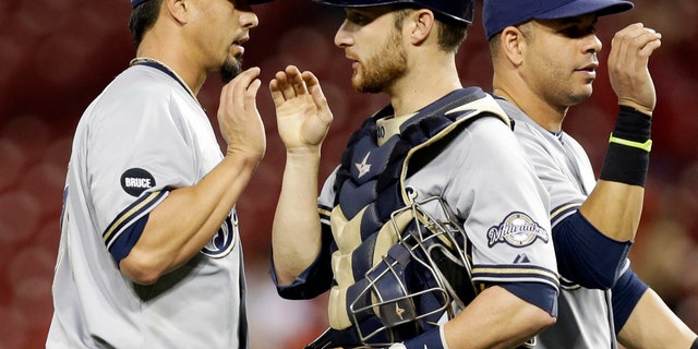 Sept. 24, 2014: In this file photo, Milwaukee Brewers starting pitcher Kyle Lohse, left, is congratulated by catcher Jonathan Lucroy, center, after the Brewers defeated the Cincinnati Reds 5-0 in a baseball game in Cincinnati.