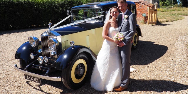 Eloise Britcher and Joseph Leney at their wedding. See MASONS story MNROLLS; A bride arrived at church in a vintage Rolls Royce that belonged to a long-lost relative - after discovering it while researching her family history. Eliose Britcher, 31, stumbled upon a mention of the classic car while reading up on her great-great uncle Alfred Shread. The wealthy fruit and veg wholesaler had bought the car in 1934, before it passed into the hands of a former spitfire pilot. But it was when Eloise was searching for information about her ancestor that she found the motor for hire by a wedding car company.