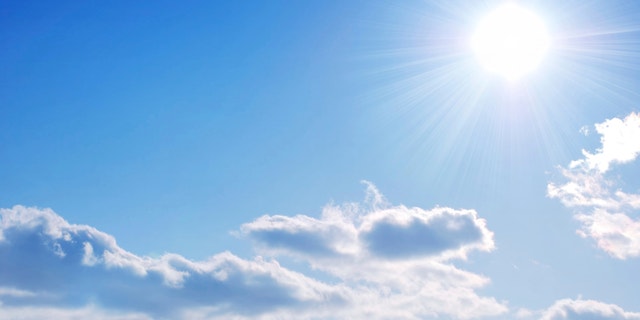 Blue sky with colouds and the Sun.