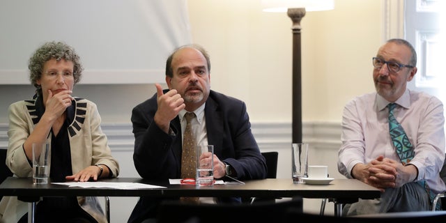 In this photo taken on Monday, Sept. 12, 2016, chief investigator Professor Freddie Hamdy, centre, and co-researchers Professor Jenny Donovan, left, and Professor David Neal, right, sit during a press briefing to announce the results of the world's first and largest trial into treatment for prostate cancer, in London. Men with early prostate cancer who choose to closely monitor their disease are just as likely to survive at least 10 years as those who have surgery or radiation, finds a major study that directly tested and compared these options. (AP Photo/Kirsty Wigglesworth)