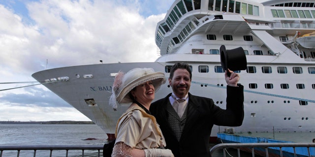 April 9, 2012: Mary Beth Crocker, left, and her husband Tom Dearing from Newport Ky. pose for pictures in period costume as they disembark the MS Balmoral Titanic memorial cruise ship at its first stop in Cobh, Ireland.