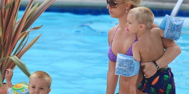 2009: Britney hangs poolside with her two young sons.