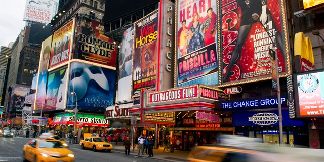 FILE - This Jan. 19, 2012 file photo shows billboards advertising Broadway shows in Times Square, in New York. Superstorm Sandy, which darkened Broadway while smashing into New York City last week, predictably ravaged the box offices around Times Square, with shows losing more than $6 million from the previous week. (AP Photo/Charles Sykes, file)