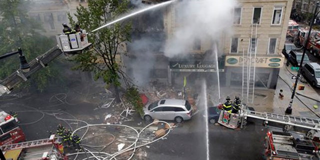 Oct. 3, 2015: Firefighters work at the at the scene of an explosion at a three-story building in the Borough Park neighborhood in the Brooklyn borough of New York.