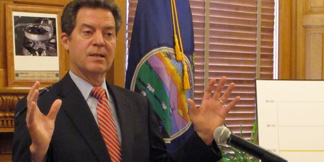 April 2, 2015: Kansas Gov. Sam Brownback answers questions from reporters about pension issues during a news conference at the Statehouse in Topeka, Kan.